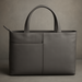 Gray leather tote bag on a gray background