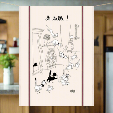 Tea towel with black and white cat illustration and 'A table!' text on a beige background