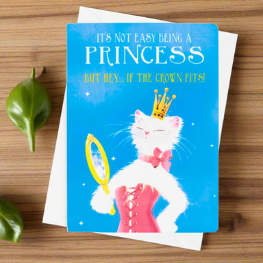 Card with a cat in a princess costume and crown on a blue background