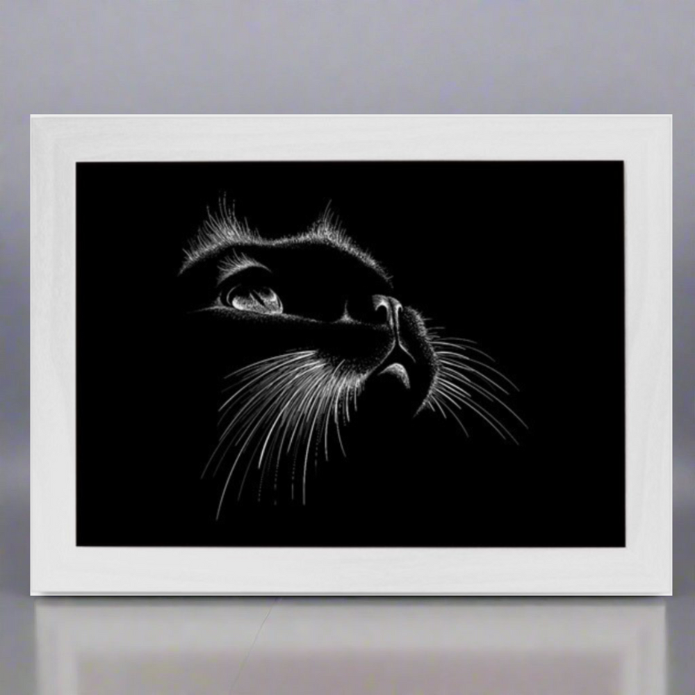 A lap tray with a white frame featuring a black and white image of a cat's face on the top surface.
