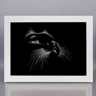 A lap tray with a white frame featuring a black and white image of a cat's face on the top surface.