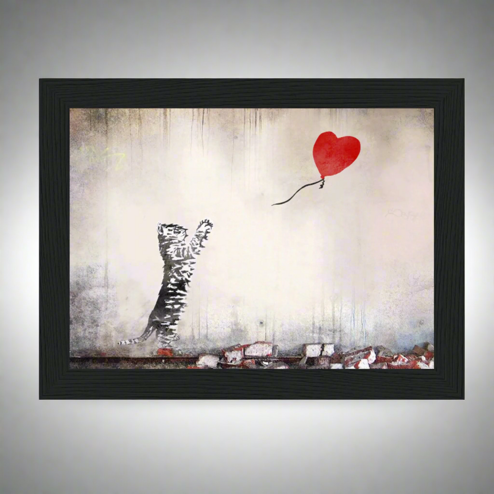 A framed print of a stylized cat with a red balloon, inspired by Banksy's iconic street artwork.