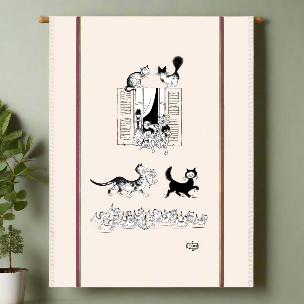 Tea towel with black and white cat illustrations on a beige background