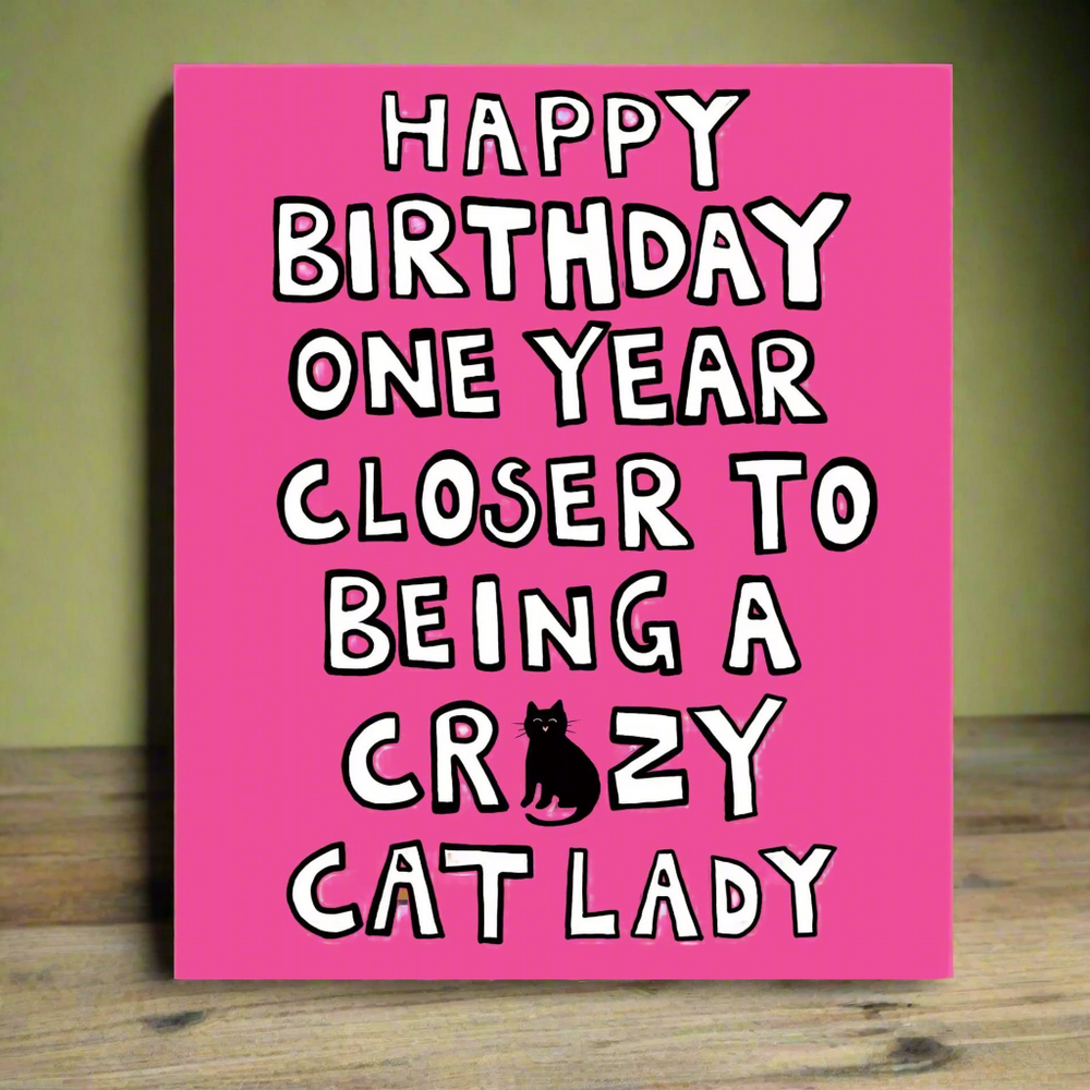 Pink card with birthday message about being one year closer to being a crazy cat lady 