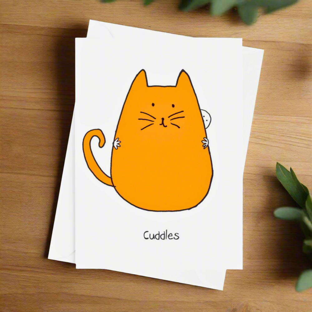 A greeting card with a cartoon illustration of an orange cat with the word 'Cuddles' written at the bottom.