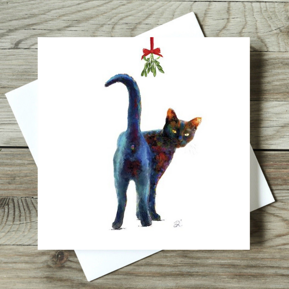 Greeting card with a colorful cat illustration on a wooden surface