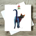 Greeting card with a colorful cat illustration on a wooden surface