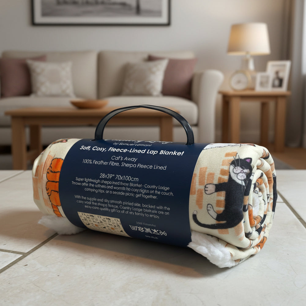 Roll-up fleece-lined lap blanket with cat design on a table in a living room setting