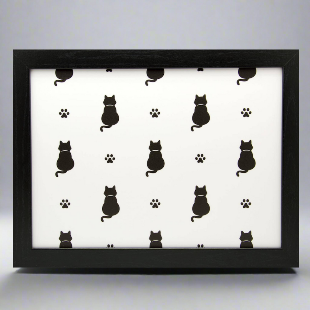 A black cat lap tray with a white background featuring a pattern of black cats and paw prints.