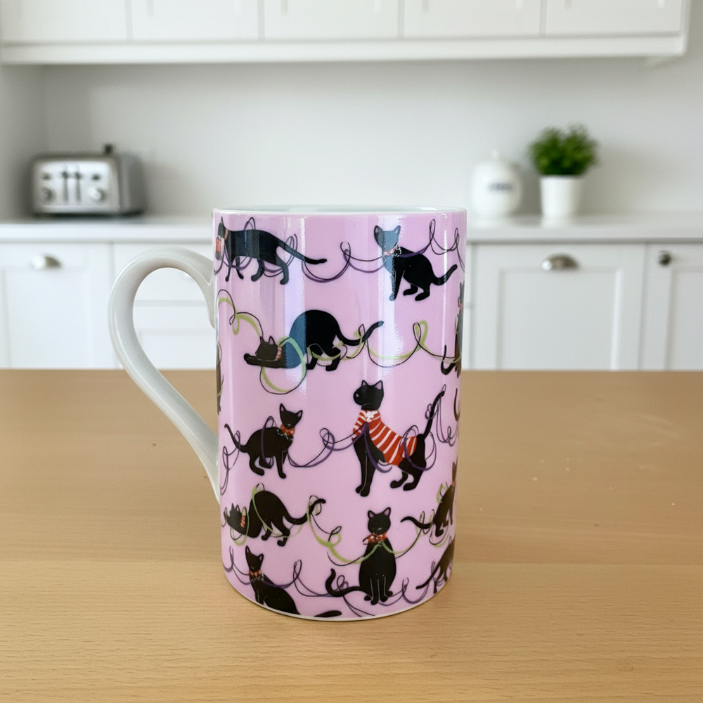 Mug with black cat pattern on a pink background in a kitchen setting