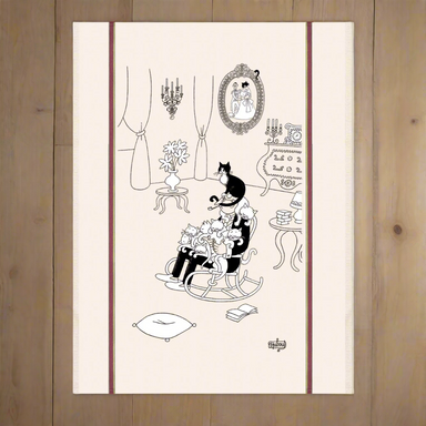 Decorative tea towel with black and white illustrations of a cat in a chair, table, and mirror on a beige background.