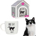 A ceramic mug with a black cat and paw print pattern, displayed alongside its packaging which is shaped like a cat house.