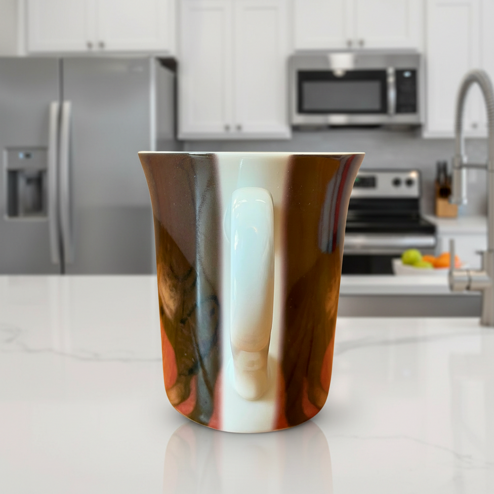 Marbled ceramic cup on a kitchen counter with modern appliances in the background
