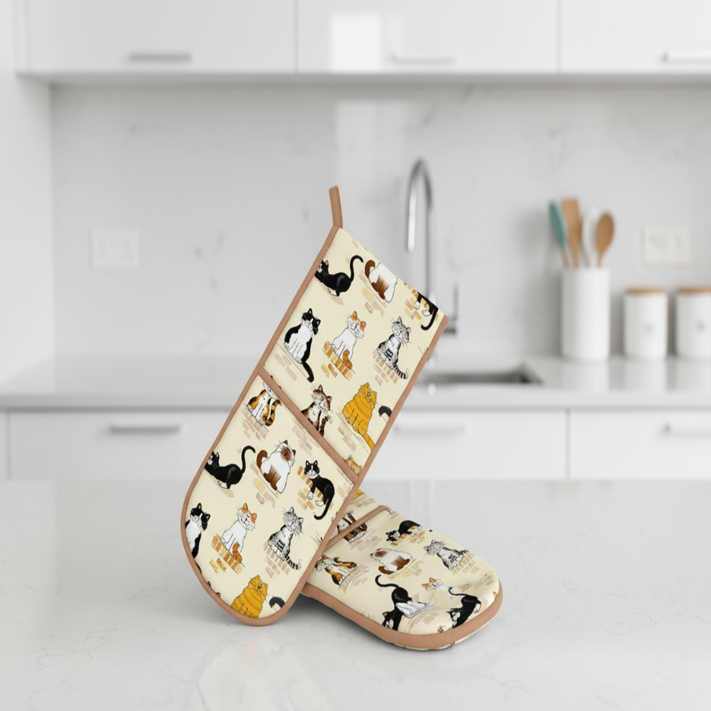 Pair of oven mitts with cat pattern on a kitchen counter