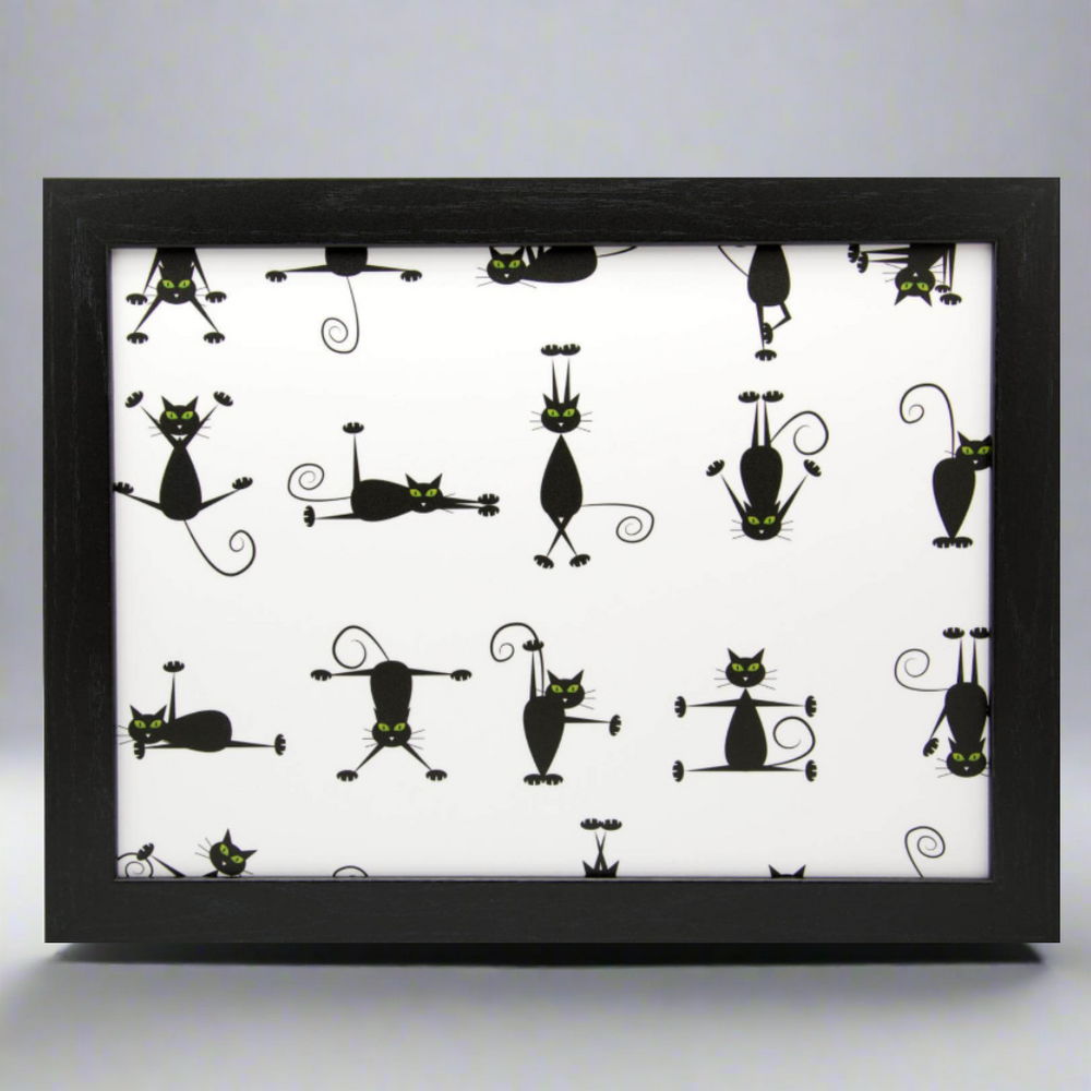 Framed artwork with black cat illustrations on a white background