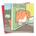 A humorous greeting card showing a cartoon of a ginger cat looking out from a door marked 'NEW HOME' with the cat saying 'Bugger!' The card is designed by Michael Canine and comes with an envelope.