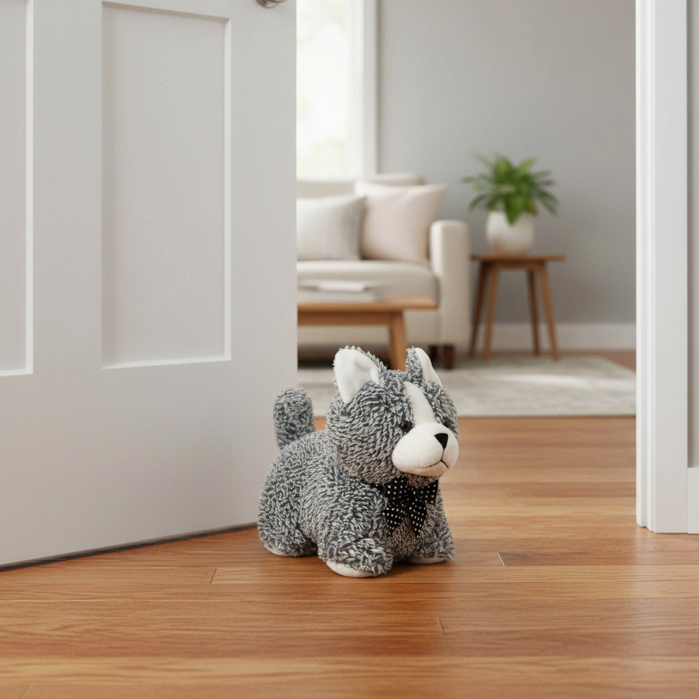 Plush cat toy on a wooden floor with a living room in the background