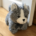 Plush toy cat with a bow tie on a wooden floor