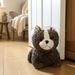 Plush cat toy on a wooden floor in a home setting